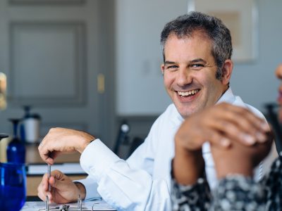 Adam Sweidan, laughing in boardroom happy CIO